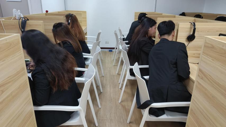 Collection agents reviewing accounts in office with No Collection No Fee policy