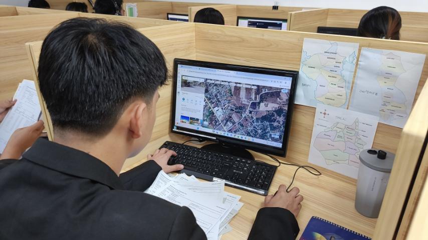 Skip tracing team analyzing location data on multiple screens with a geographic map